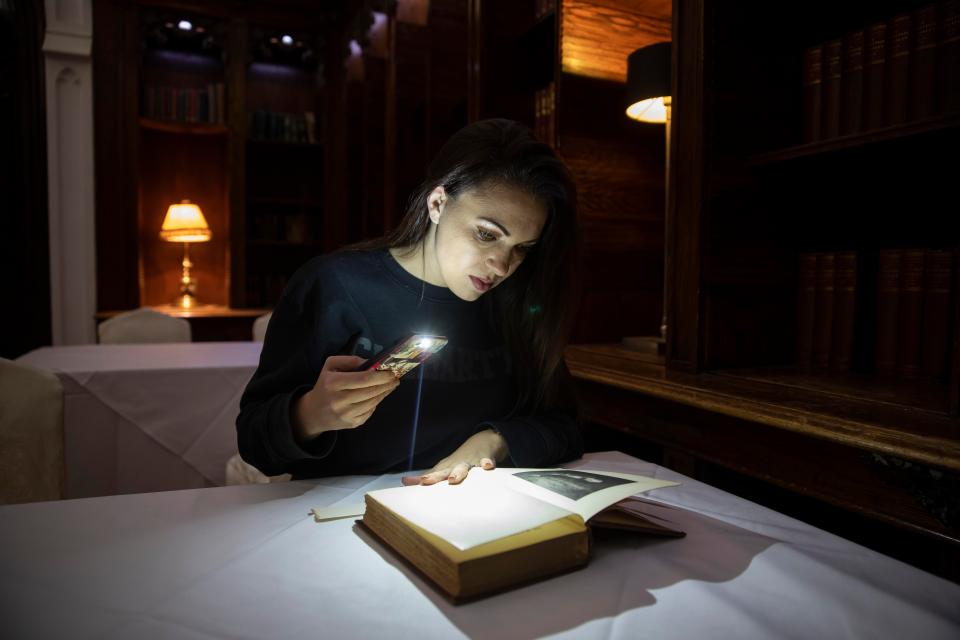 Nicola in the library reading the book by Sir Walter Scott called St.Ronan's Well which often flies off the shelf by itself during the night