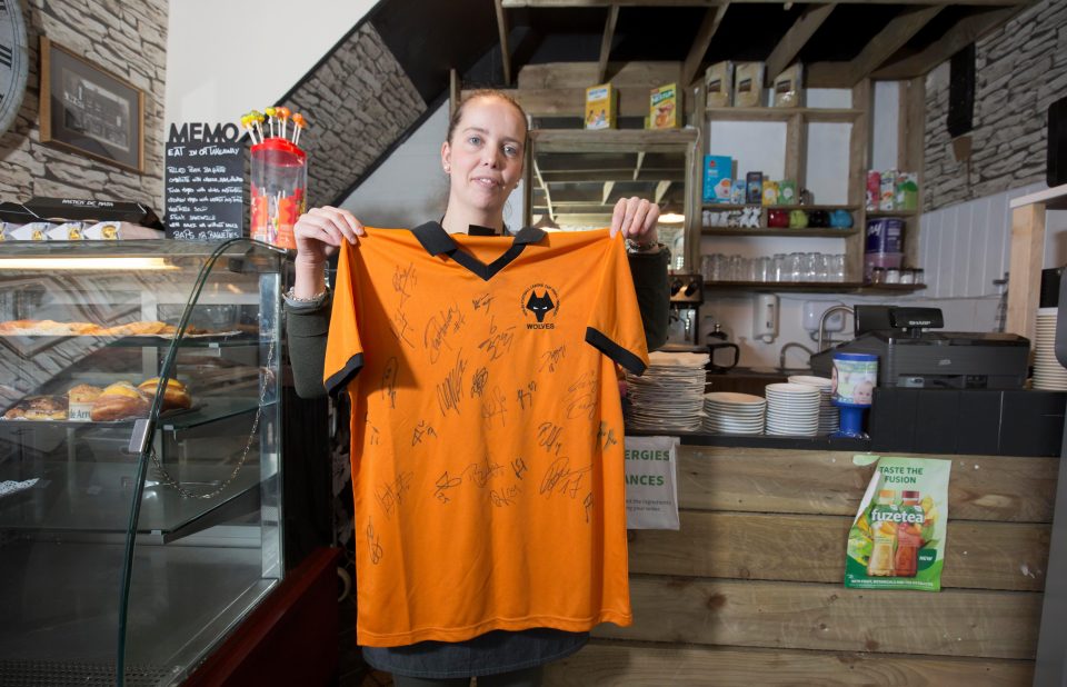  Lopes proudly holds aloft a Wolves jersey signed by the players