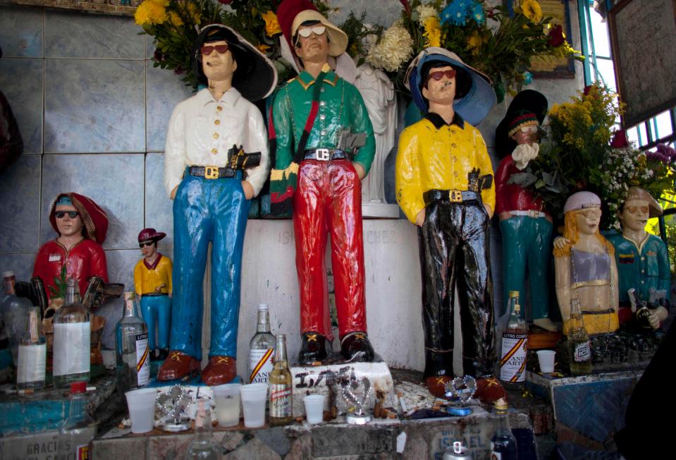  Pictured are some of the gangsters who are worshipped at the shrine in Venezuela