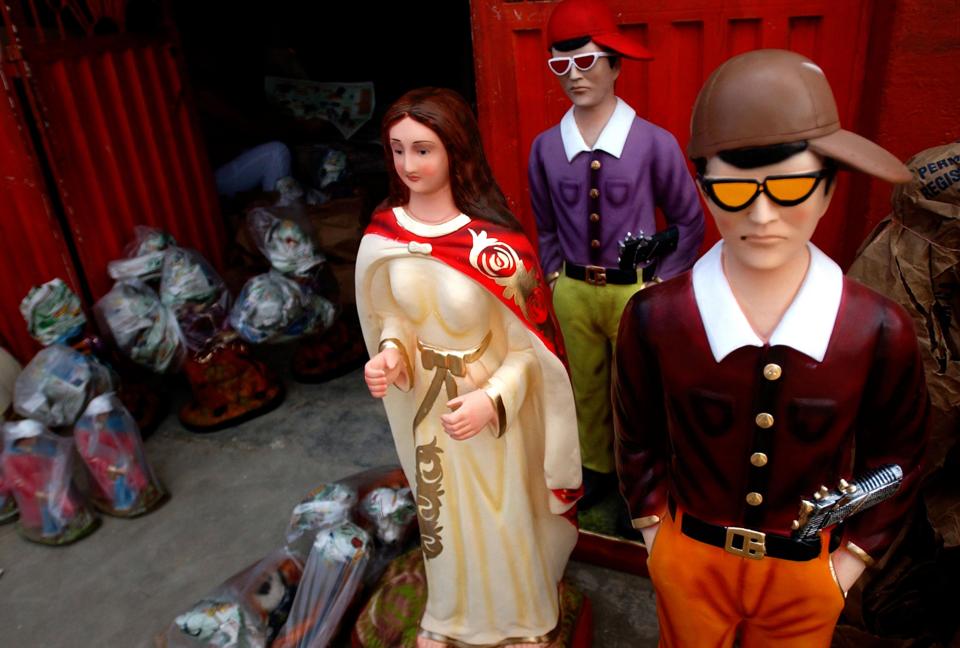  Pictured are statues of criminals wearing pistols at a ceramics workshop in San Cristobal, Venezuela