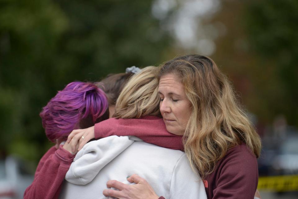  Distraught locals embrace after the mass shooting in Pittsburgh