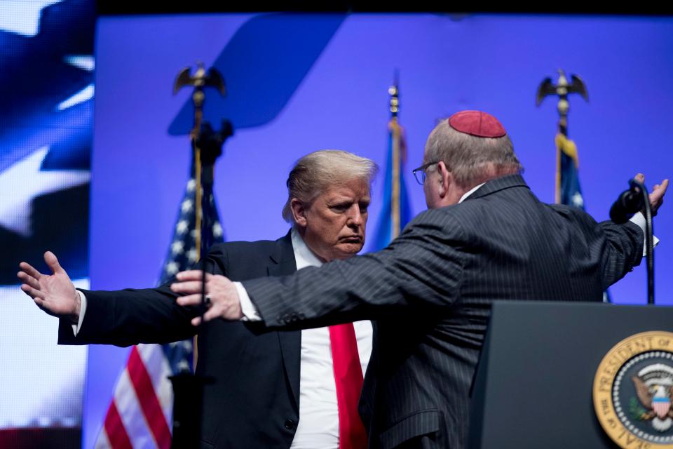  Trump, pictured with a leading rabbi at an event in Indianapolis today, said the synagogue should have had armed guards