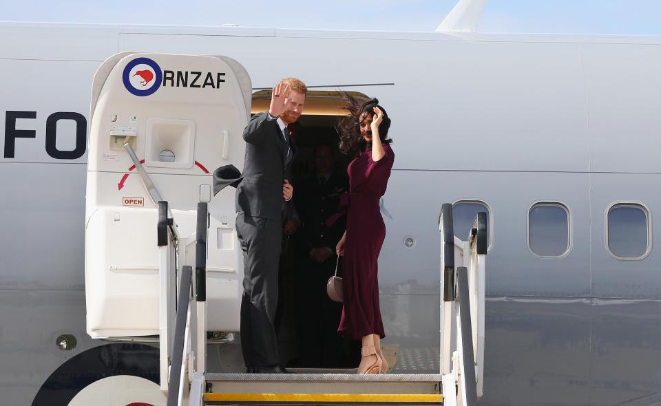  Prince Harry, Duke of Sussex and Meghan, Duchess of Sussex wave goodbye as they depart Sydney Airport