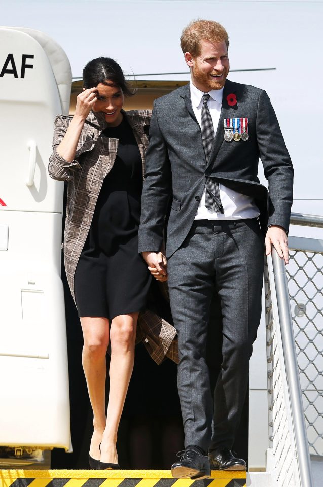  Meghan struggled with the wind as the couple landed in New Zealand