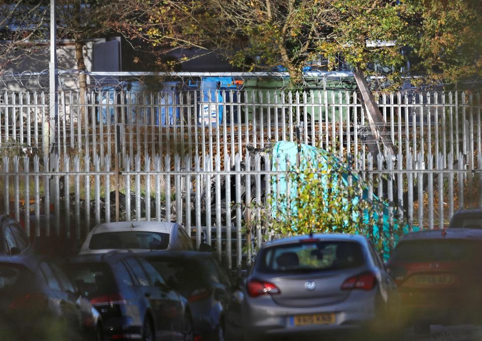  The burnt shell of the helicopter of the club owner Thai businessman Vichai Srivaddhanaprabha, that crashed when leaving the ground on Saturday evening after the match, can be seen outside the Leicester City stadium this morning