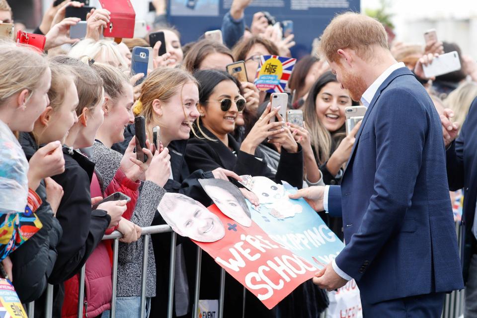  Harry banters with the crowd after spotting a sign saying 'we're skipping school 4 you'