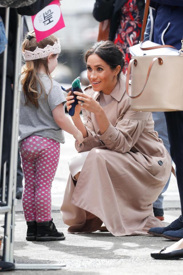  Meghan meets a little princess with a soft toy and knitted crown