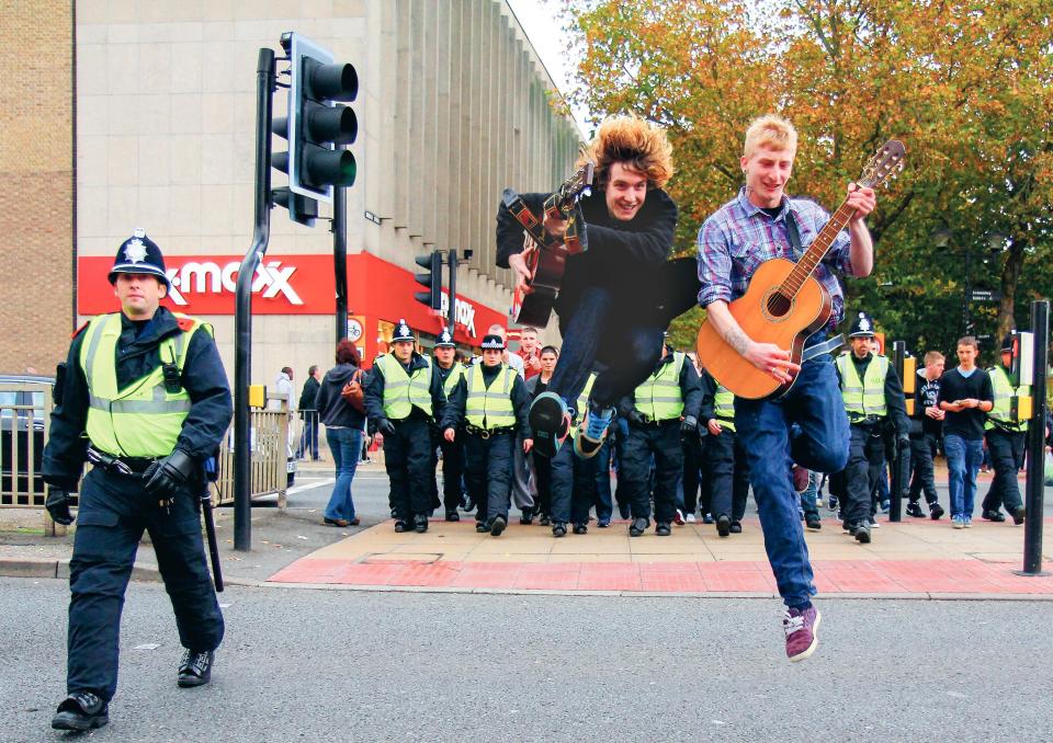  Peterborough musicians and cops marching across the street