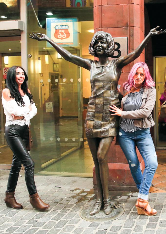  Liverpudlians posing with a statue of local legend Cilla Black