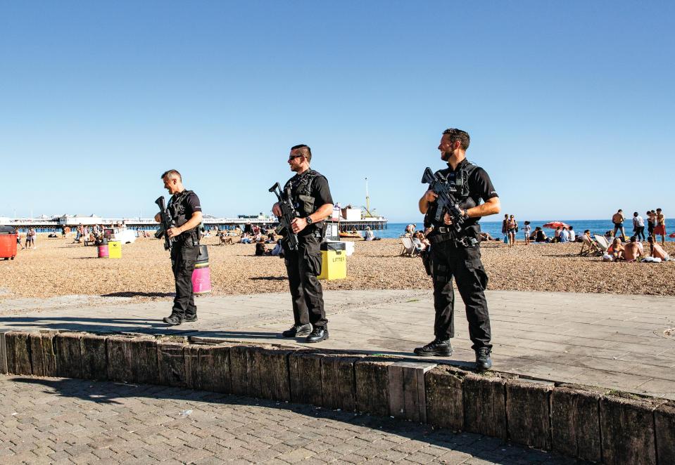  Armed cops keeping watch at the seaside