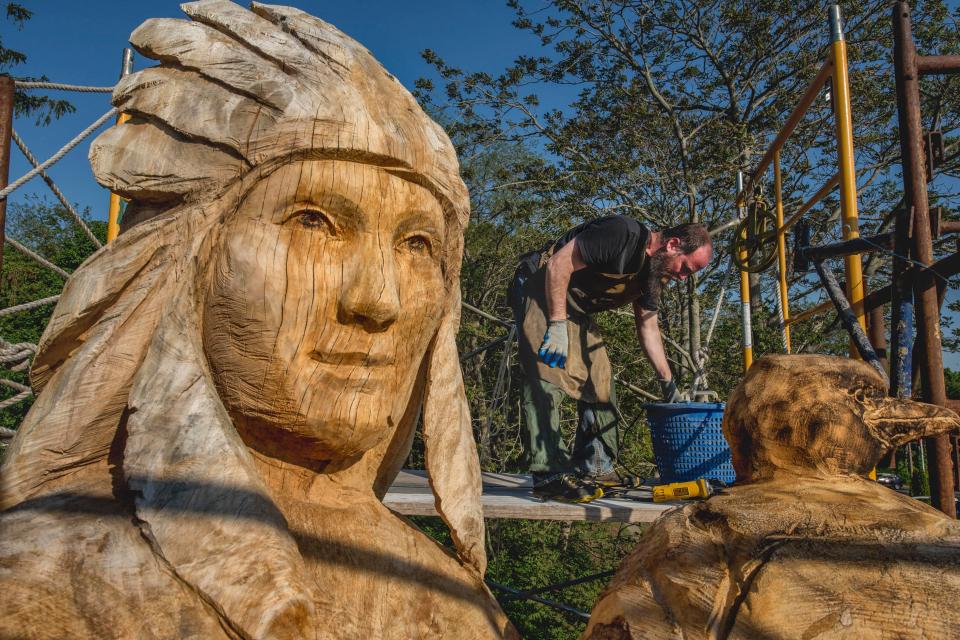  A sculptor works on a 32-foot-tall carving of the Native American princess of Lake Ronkonkoma