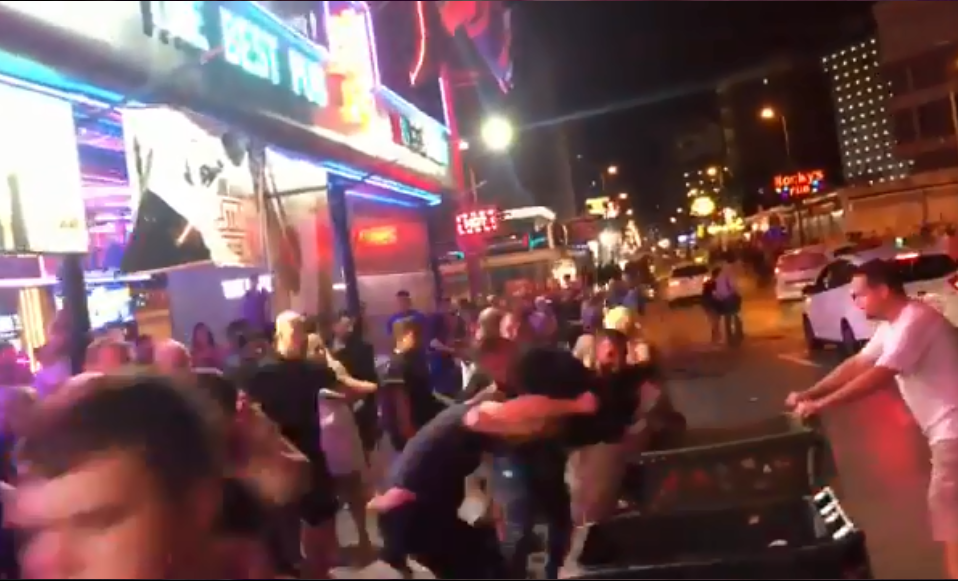  The two men collide with a bin as they grapple