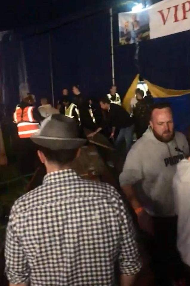  The fighters being removed from the large tent by security staff