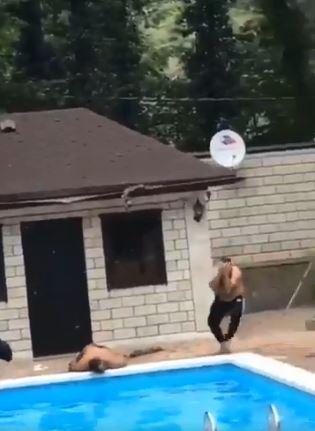  His horrified friend rushes over as the man appears to be knocked out cold beside the pool