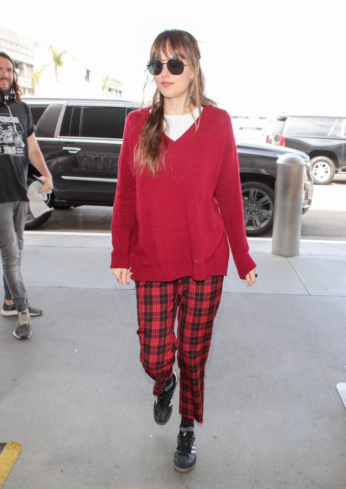  Dakota Johnson nails casual chic in tartan trousers and Adidas trainers