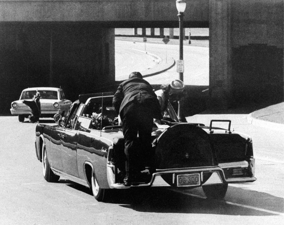 Clint Hill is pictured here after jumping on to the back of JFK’s car as Oswald shot at the president