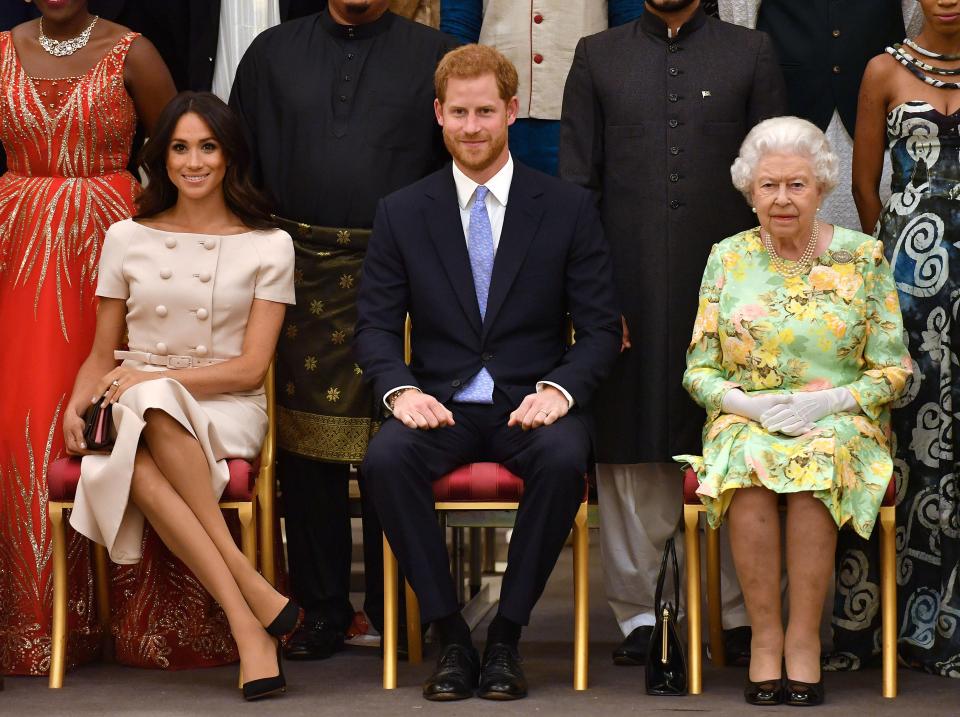  The Queen with the Duke and Duchess of Sussex pose for a picture at a Buckingham Palace reception following the final Queen's Young Leaders Awards Ceremony in June