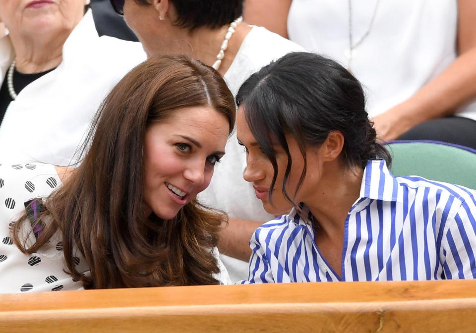  At Wimbledon Kate leans in and whispers in Meghan's ear as she speaks to her