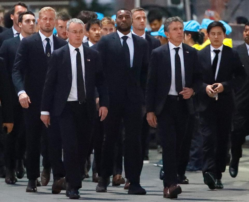  Wes Morgan leads his teammates towards the temple after racing through the night to reach the funeral