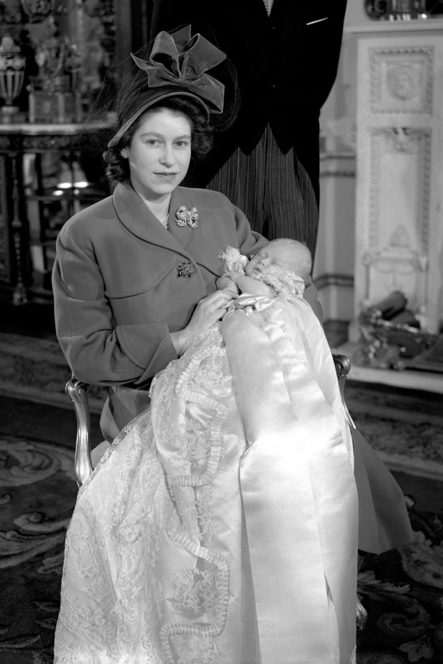  1948: Princess Elizabeth holding her infant son, Prince Charles, after his Christening ceremony at Buckingham Palace