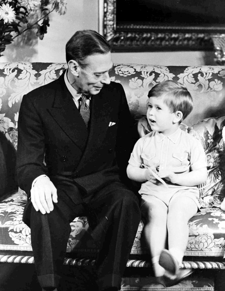  1951: King George VI with his grandson Prince Charles celebrating his third birthday at Buckingham Palace