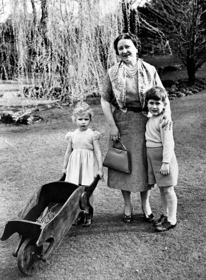  1954: Princess Anne wheeling her barrow and Prince Charles cuddling up to his grandmother, the Queen Mother