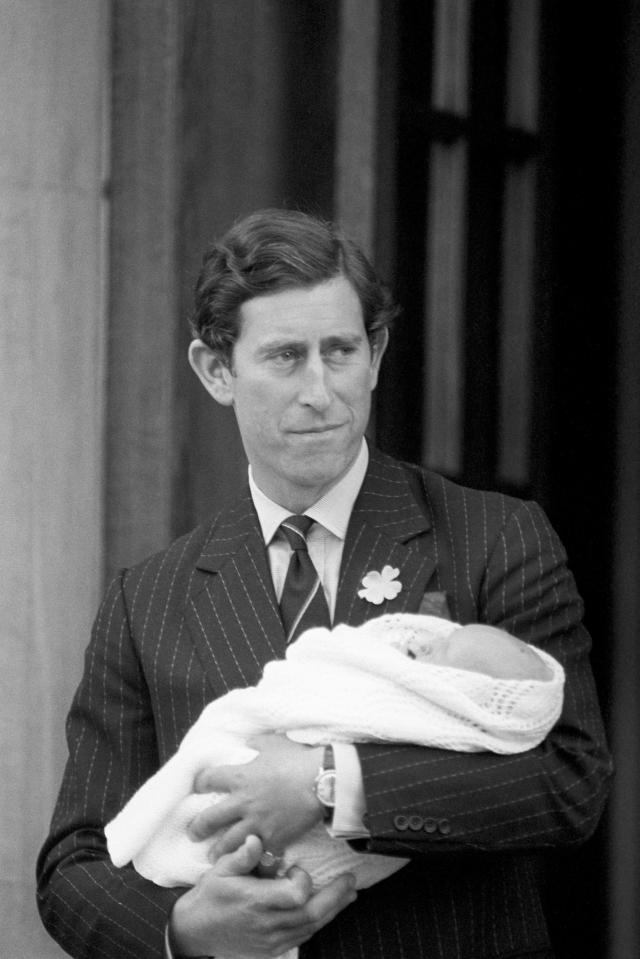  1982: The Prince of Wales, holds his newborn son Prince William as they leave St. Mary's Hospital, Paddington