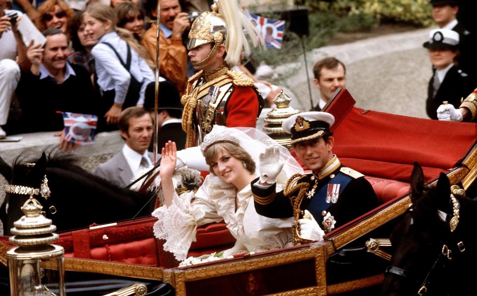  1981: The Prince of Wales and his bride, the Princess of Wales, making their way to Buckingham Palace in an open-top carriage after their wedding ceremony at St. Paul's Cathedral in Londo