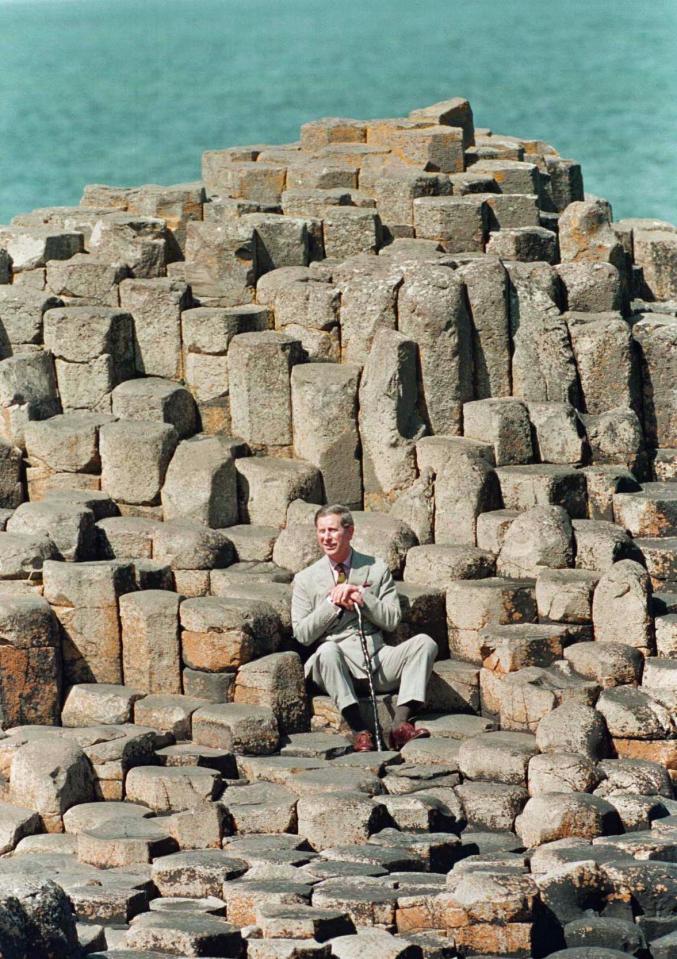  1996: Prince Charles with a traditional Irish blackthorn stick in his hand, sitting on the stones in the Giant's Wishing Chair at the Giant's Causeway, Co Antrim