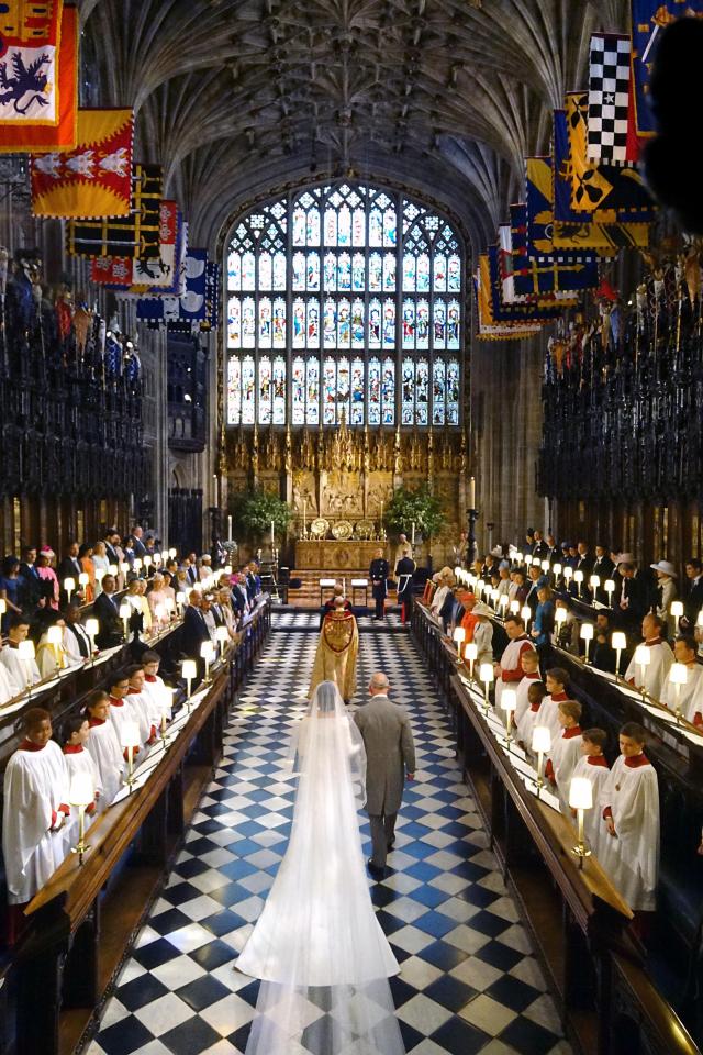  2018: The Prince of Wales walking Meghan Markle up the aisle of St George's Chapel at Windsor Castle for her wedding to Prince Harry