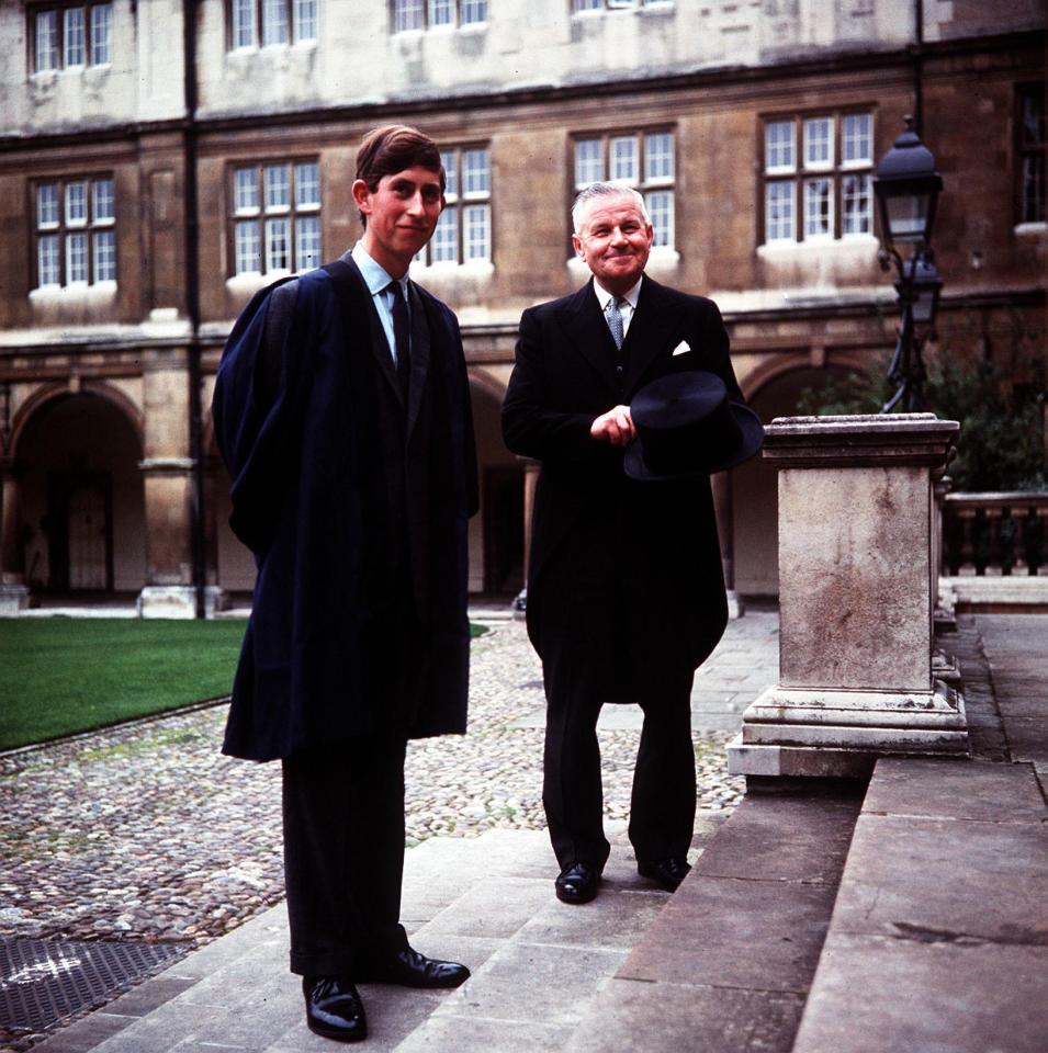  1967: Prince Charles, wearing the Trinity gown of blue silk with black facings, accompanied by head porter, Mr Bill Edwards, posing on the steps of Neville Court, Cambridge University