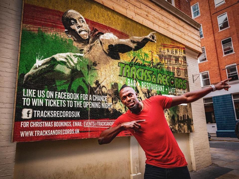  Bolt in his famous pose outside the restaurant ahead of the London opening