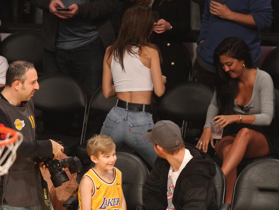  A man was snapped staring at the model's peachy bum at a basketball game