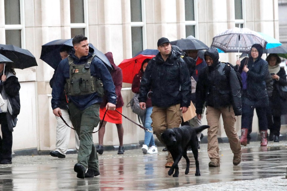 Armed police with dogs patrol outside the Brooklyn Federal Courthouse