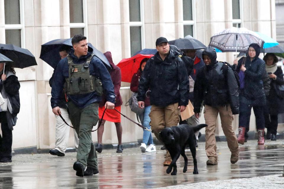  Armed police with dogs patrol outside the Brooklyn Federal Courthouse