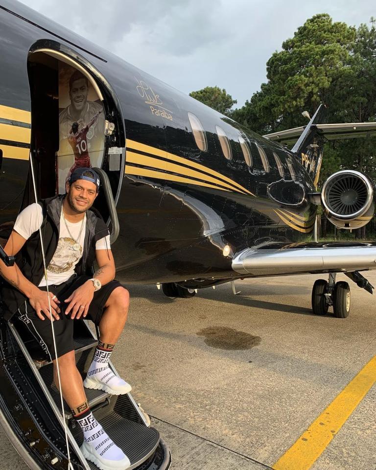 Hulk stands outside his private jet, which bears the striker's signature on the outside