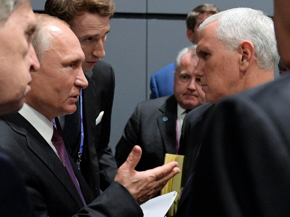  Russian President Vladimir Putin, left, gestures as he speaks to US Vice President Mike Pence at the Association of Southeast Asian Nations summit in Singapore, Thursday, November 15