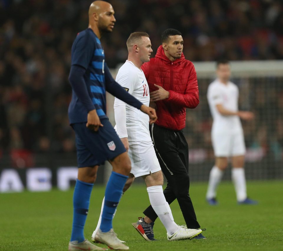  A pitch invader got to Rooney and appeared to ask for his shirt