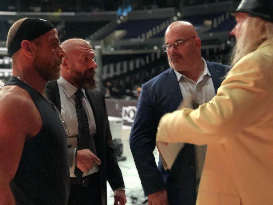  Triple H is already back at work wearing a sling on his damaged arm