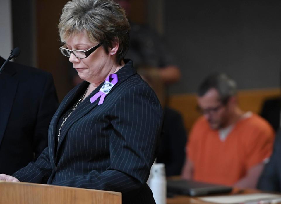  Sandy Rzucek, the mother of Shanann Watts, reads a statement during court at the Weld County Courthouse on Monday - Watts can be seen behind her