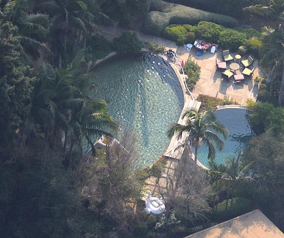  The pool is surrounded by inflatables and a chilled seating area