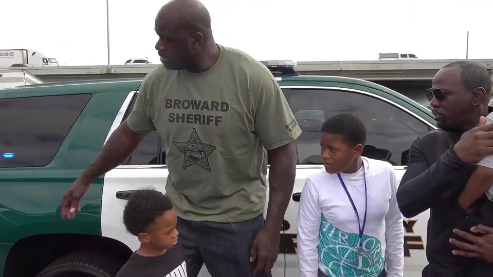  Shaq can be seen consoling two young boys who were involved in the collision