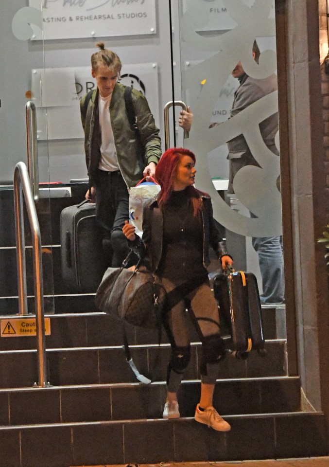 Dianne carried a suitcase and overnight bag as she arrived at Joe’s apartment