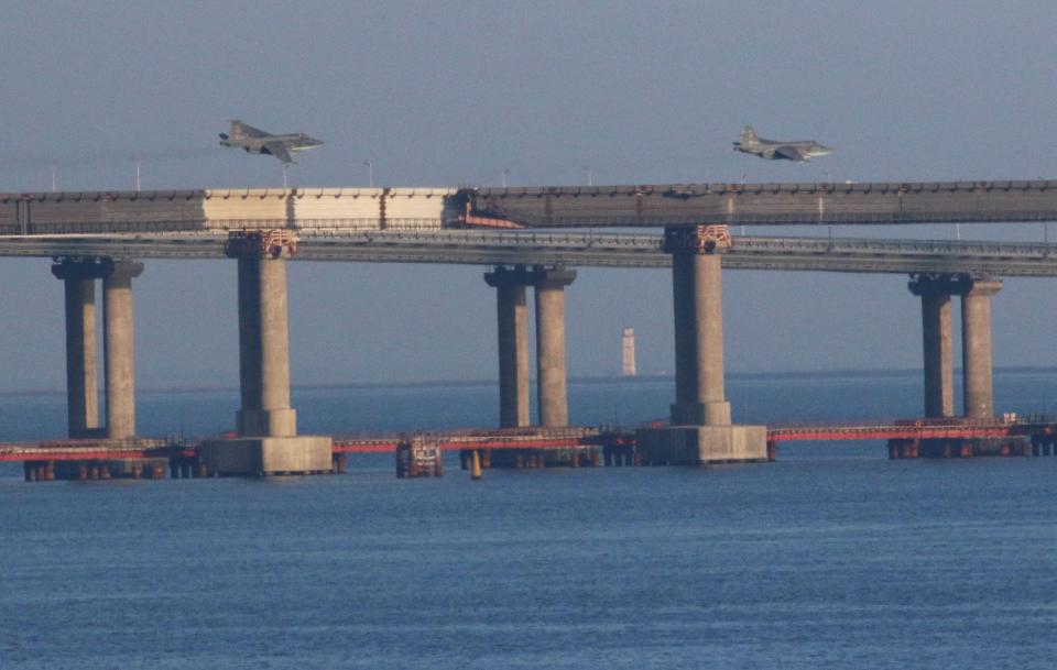  Russian fighter jets fly over the Crimean Bridge after three Ukrainian vessels were stopped by Russia from entering the sea of Azov