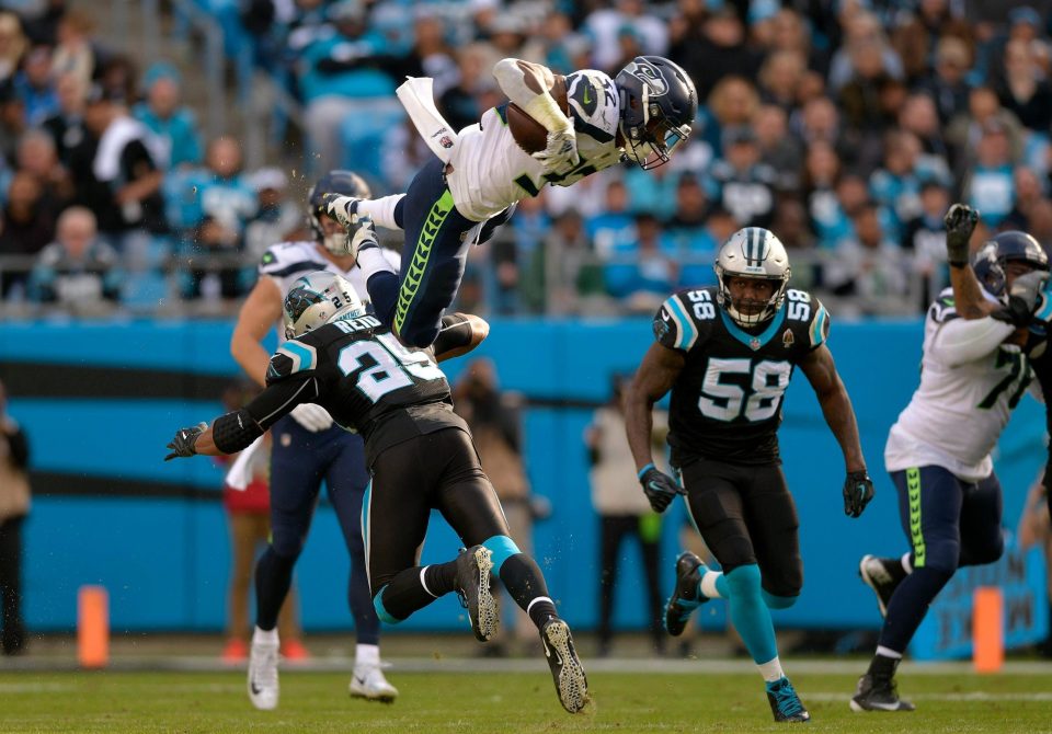  Carson attempted to hurdle Eric Reid but caught his ankle and was sent spinning into the air