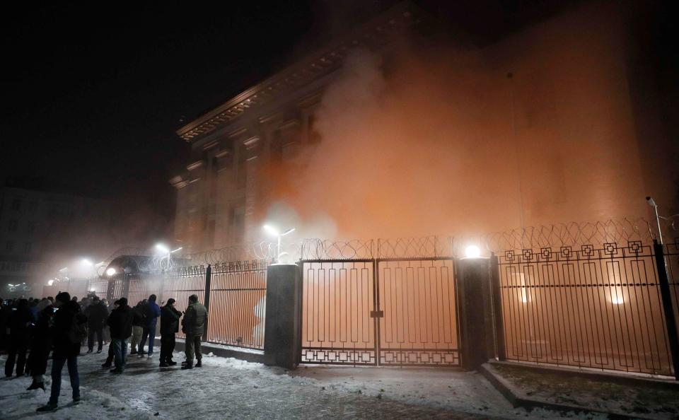  Protesters chuck flares outside the Russian embassy in Kiev after three Ukrainian boats were seized