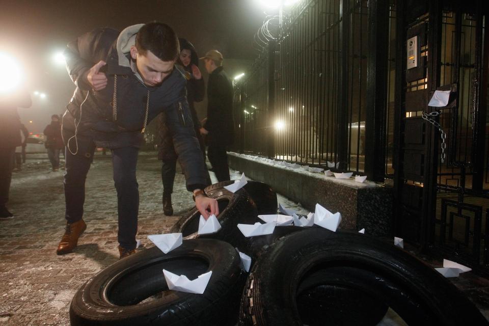  Protesters set up paper ships on the tires during their rally near of Russian embassy building