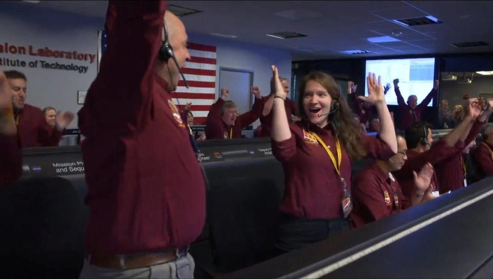  The mission control team at Nasa's Jet Propulsion Laboratory cheers as InSight lands on the planet's surface after nearly seven months in transit