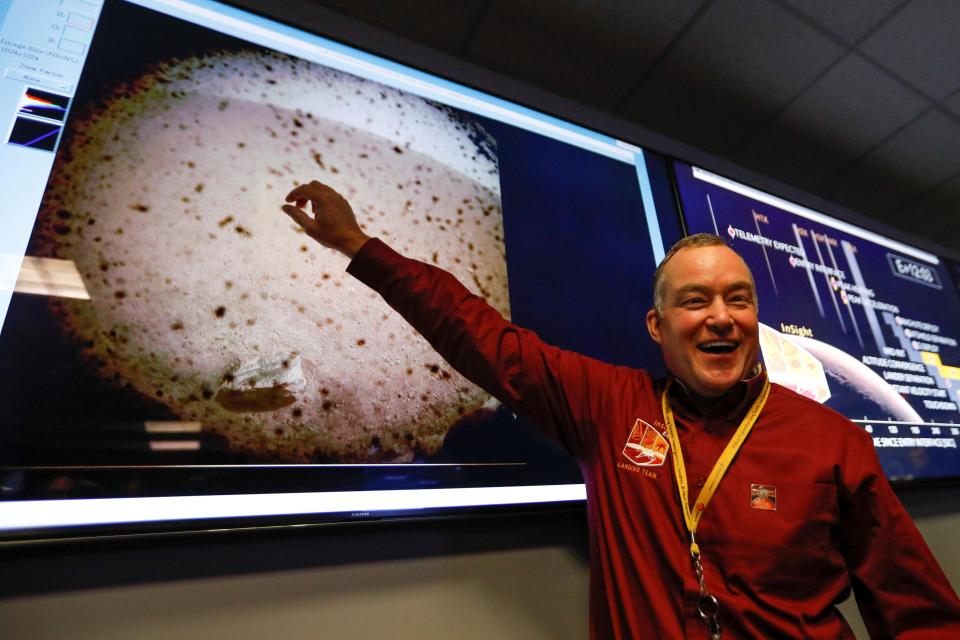  Project manager Tom Hoffman points to the first picture sent back to Earth from Mars by the spaceship InSight at NASA's Jet Propulsion Laboratory (JPL) in Pasadena, California