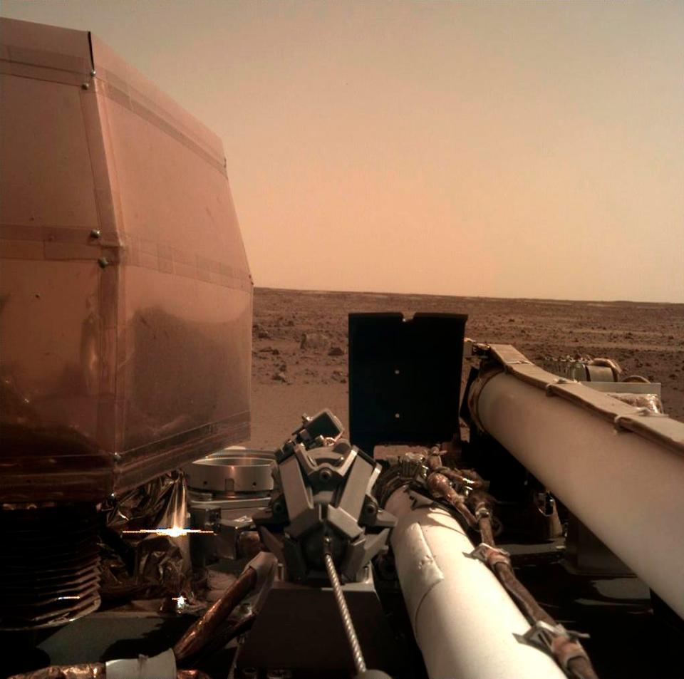  This Nasa photo shows an image on Mars that its spacecraft took using its robotic arm-mounted Instrument Deployment Camera after it landed on the planet yesterday